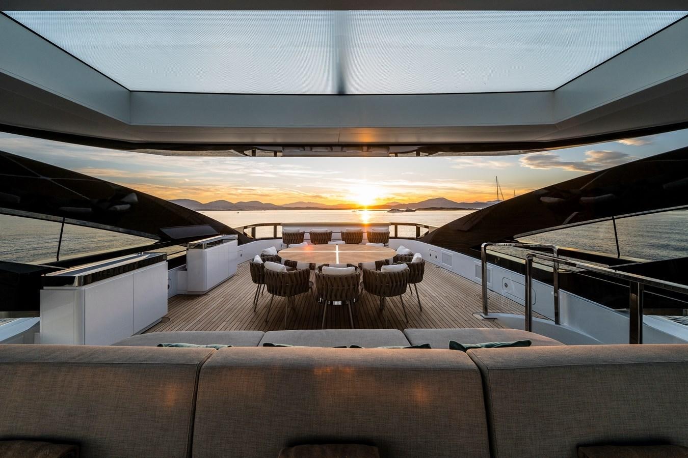 a room with a large white and orange ceiling and a large white and black table with chairs and aboard ISA GT 45 Yacht for Sale