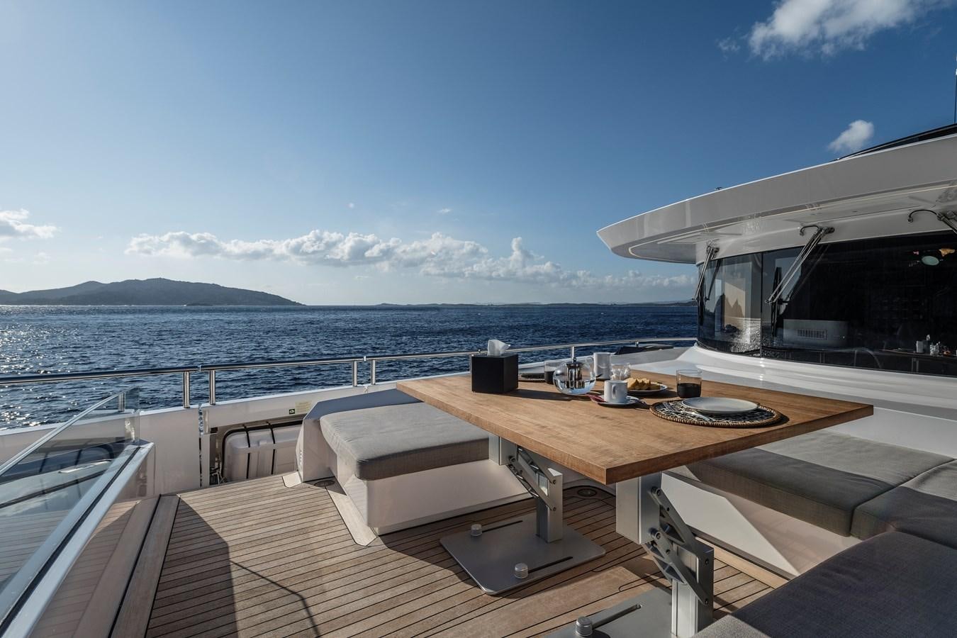 a deck with a table and chairs on it aboard ISA GT 45 Yacht for Sale