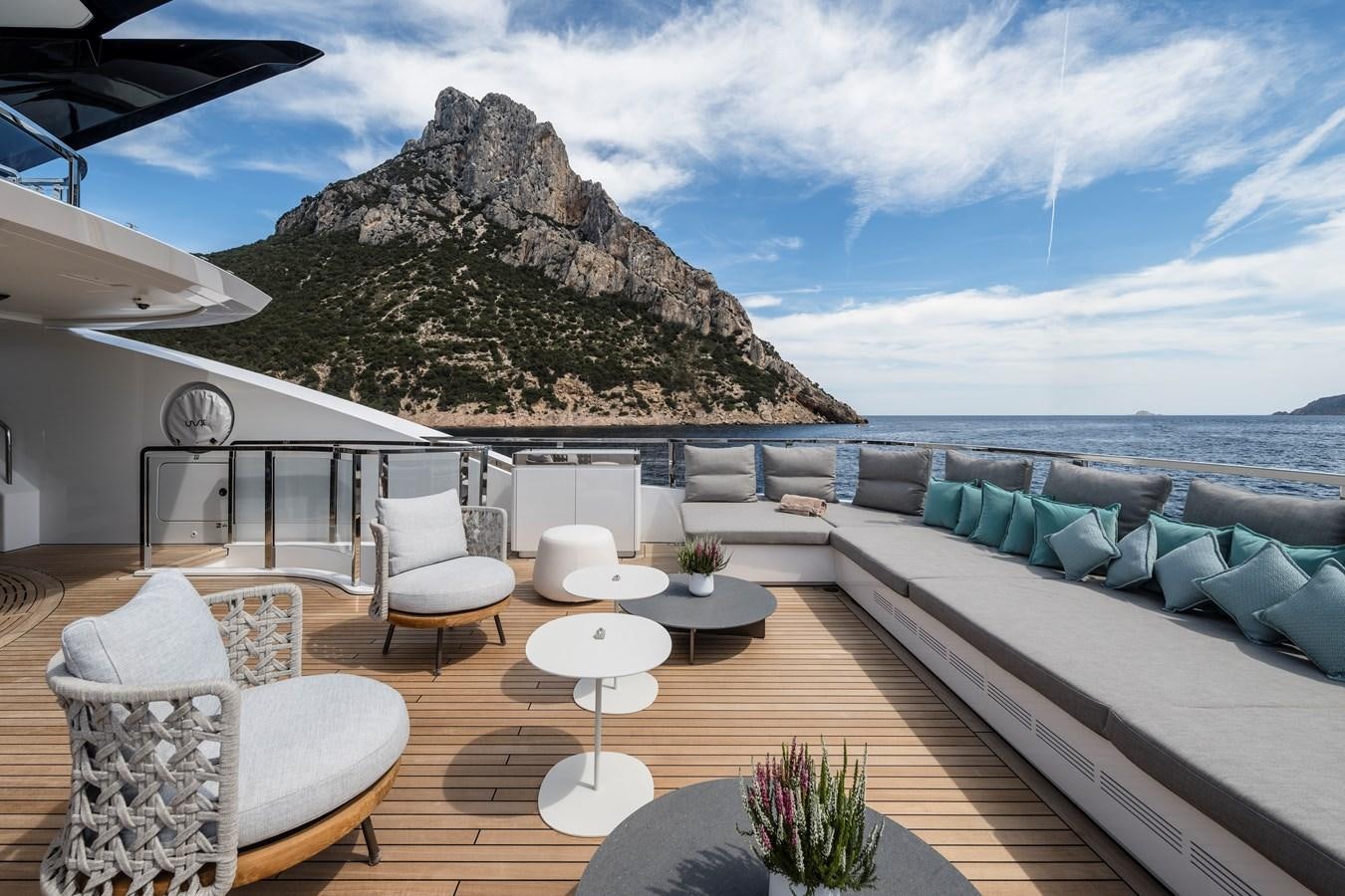 a patio with a large rock mountain in the background aboard ISA GT 45 Yacht for Sale