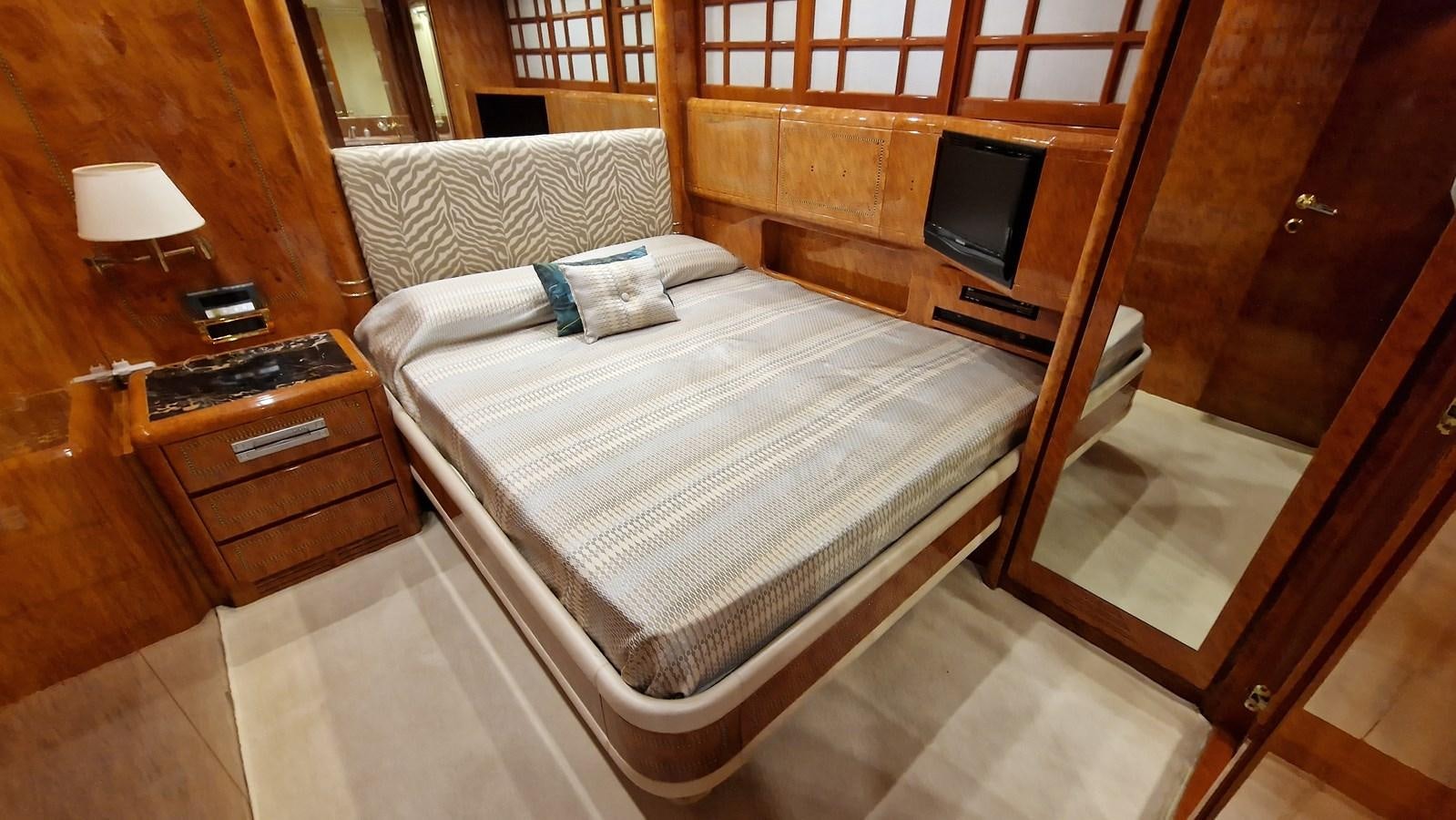 a bed with a television on the side aboard BLUE TRINITY Yacht for Sale