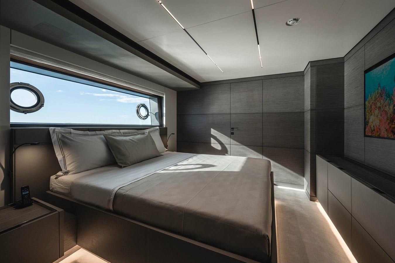 a room with a bed and a window aboard REGINA Yacht for Sale