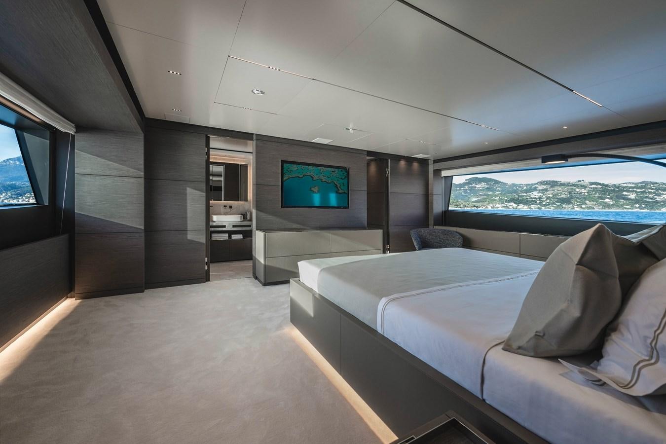 a room with a bed and a tv on the wall aboard REGINA Yacht for Sale