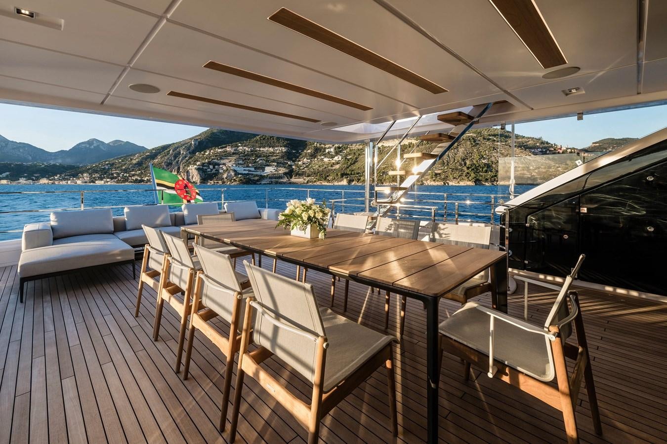 a deck with a table and chairs aboard REGINA Yacht for Sale