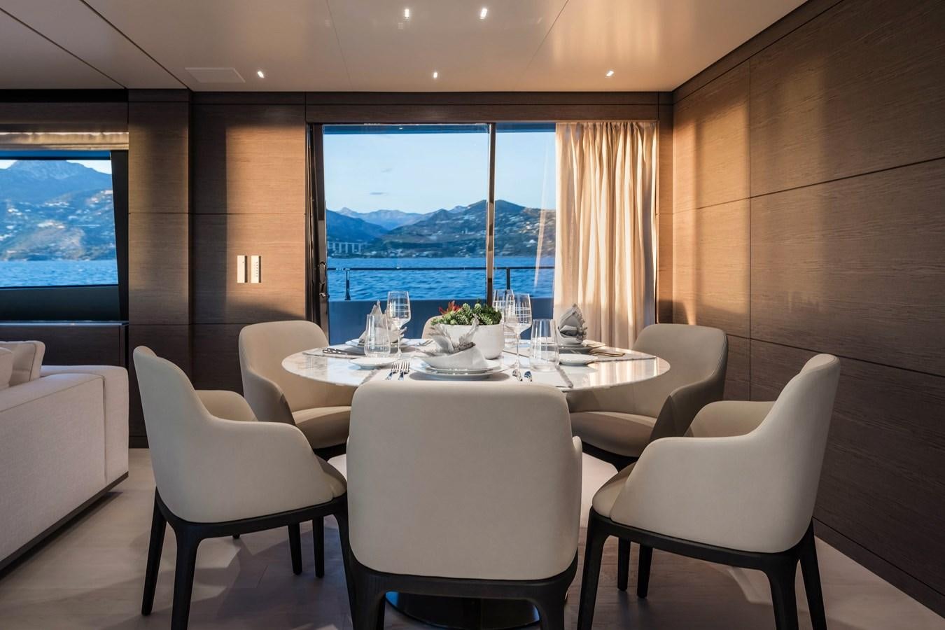 a room with a table chairs and a window aboard REGINA Yacht for Sale