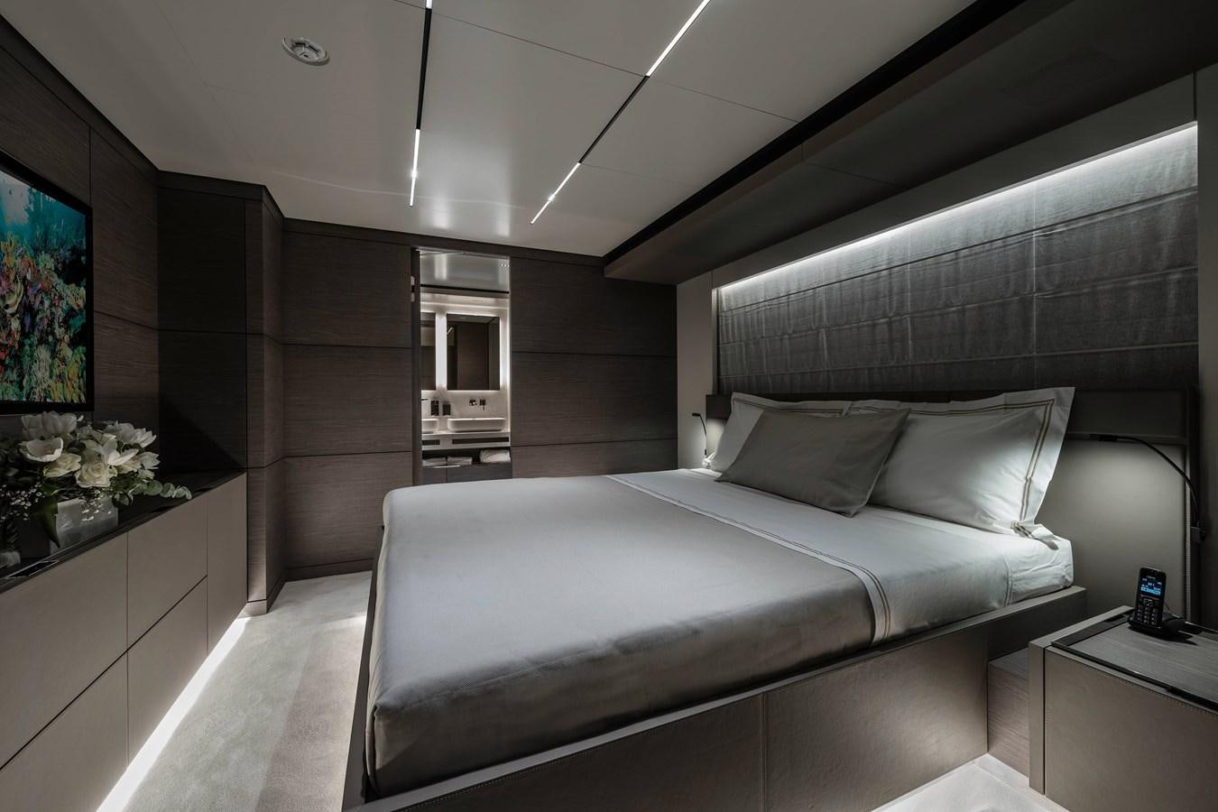 a room with a bed and a desk aboard REGINA Yacht for Sale