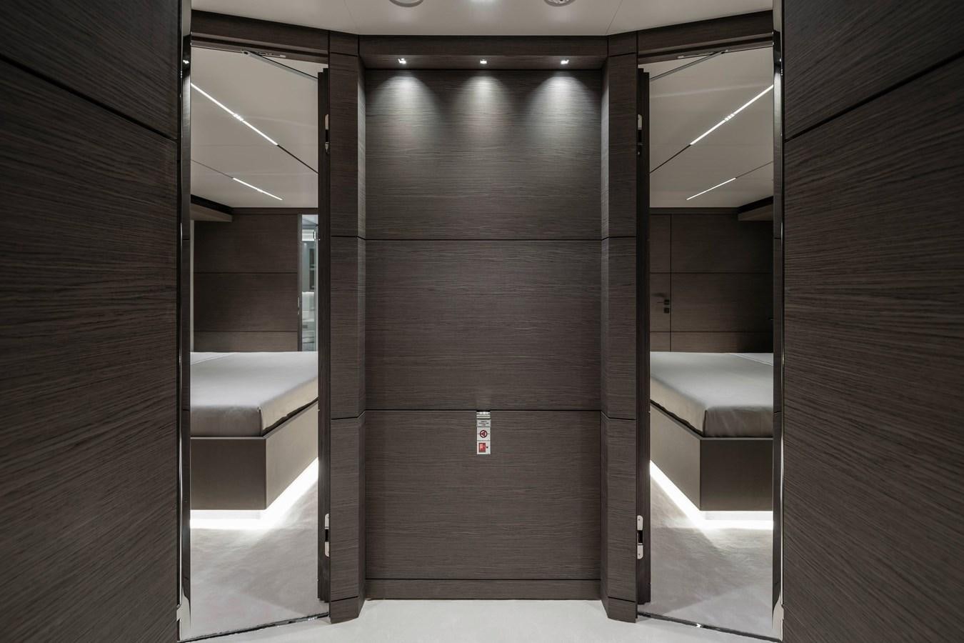 a room with a bed and a desk aboard REGINA Yacht for Sale