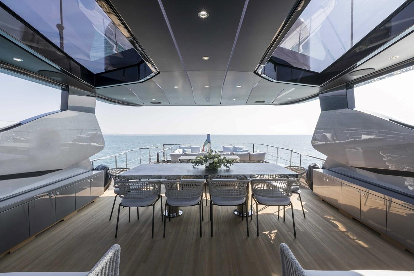 a large room with a table and chairs and a large ship aboard CRAZY TOO Yacht for Sale