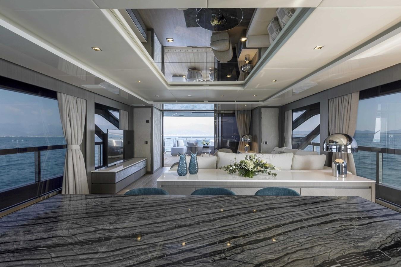 a large living room with a large open window aboard CRAZY TOO Yacht for Sale