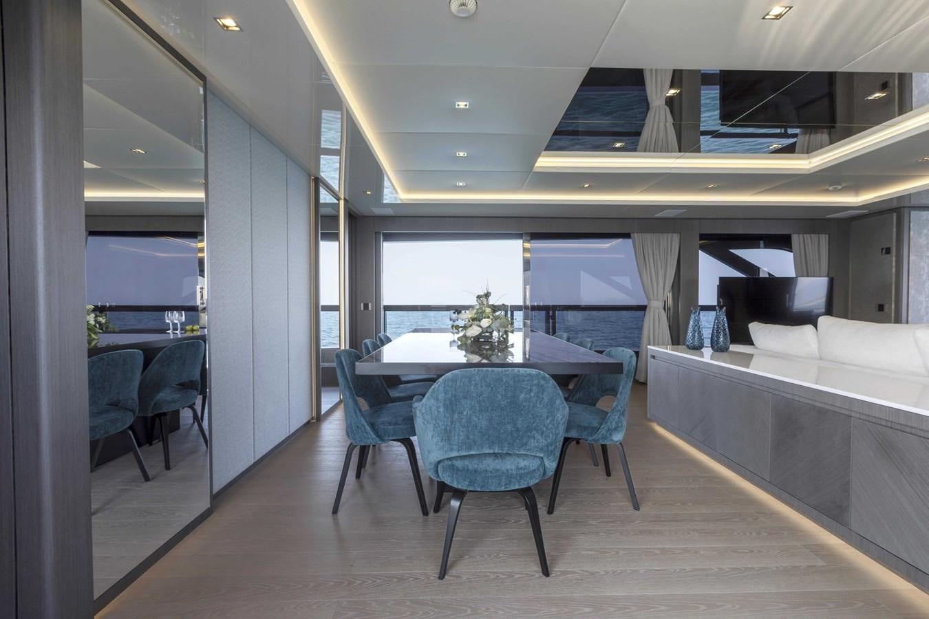 a room with a table and chairs aboard CRAZY TOO Yacht for Sale
