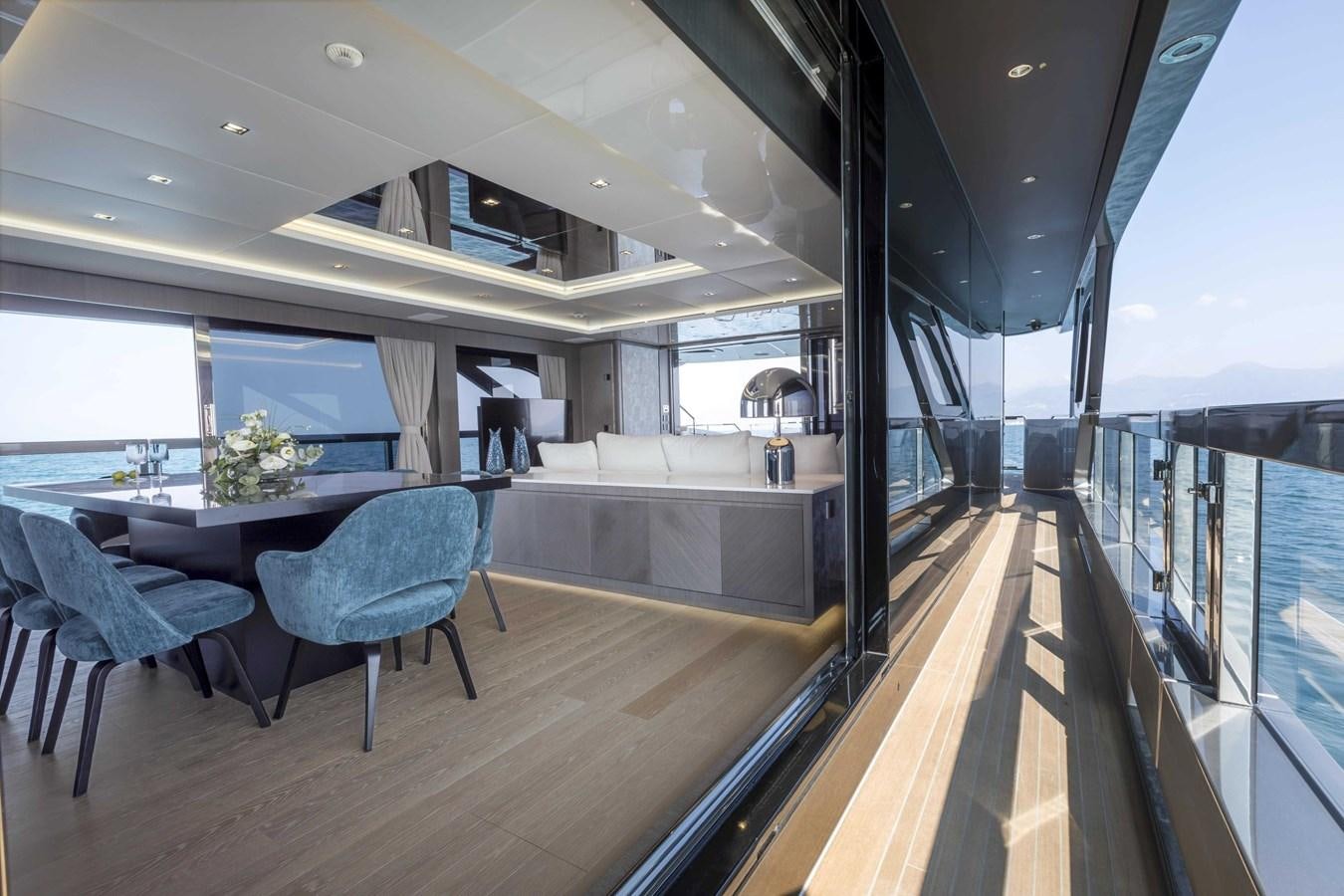 a room with a table and chairs aboard CRAZY TOO Yacht for Sale