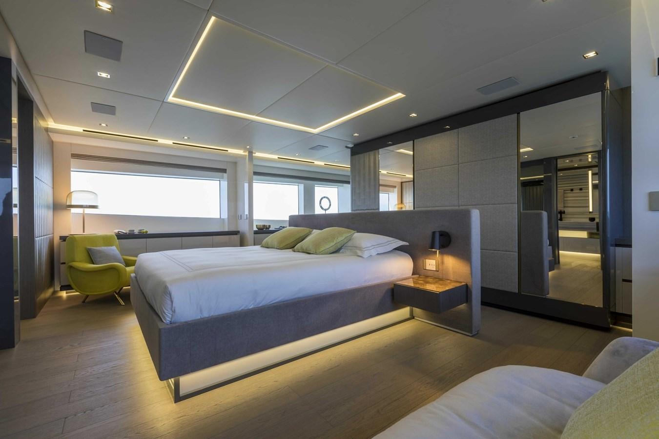 a room with a bed and a desk aboard CRAZY TOO Yacht for Sale