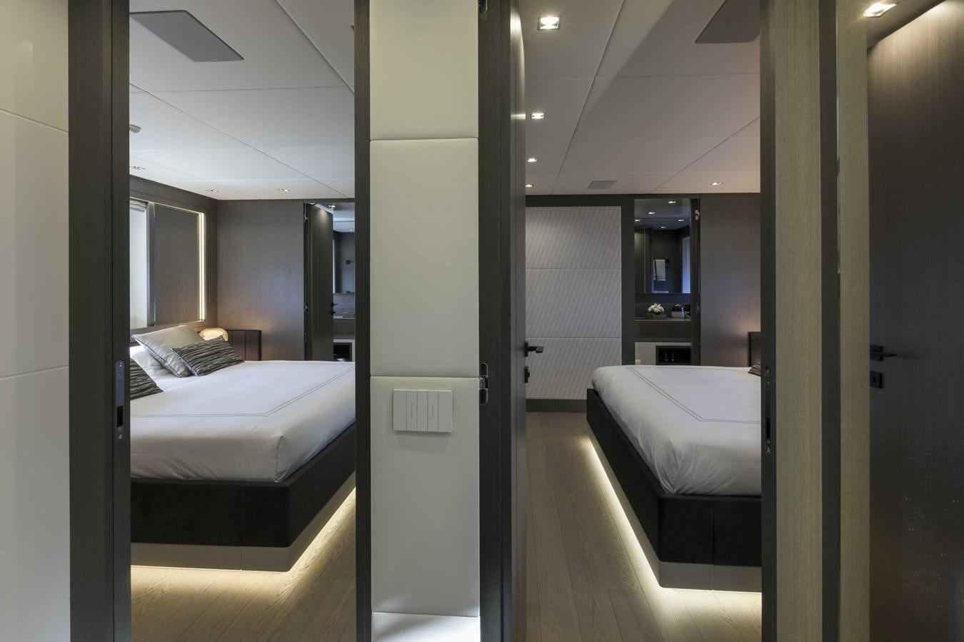 a room with a bed and a mirror aboard CRAZY TOO Yacht for Sale
