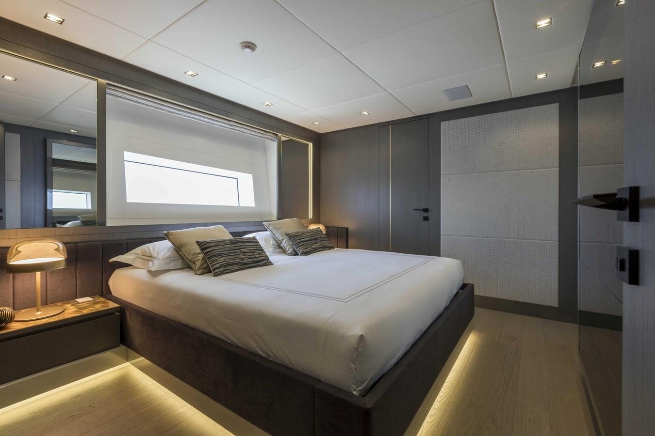 a room with a bed and a mirror aboard CRAZY TOO Yacht for Sale