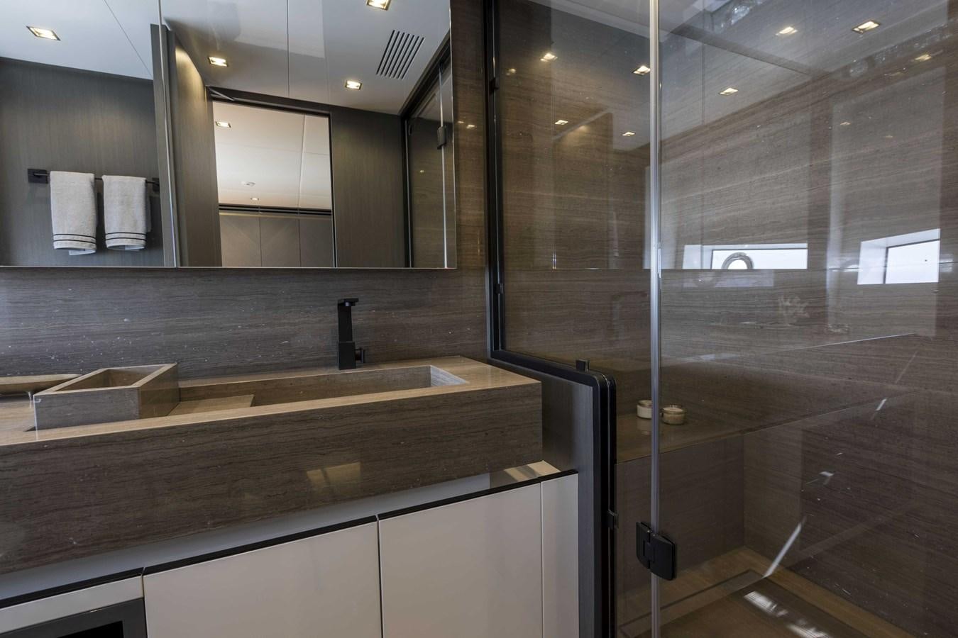 a bathroom with a large mirror aboard CRAZY TOO Yacht for Sale