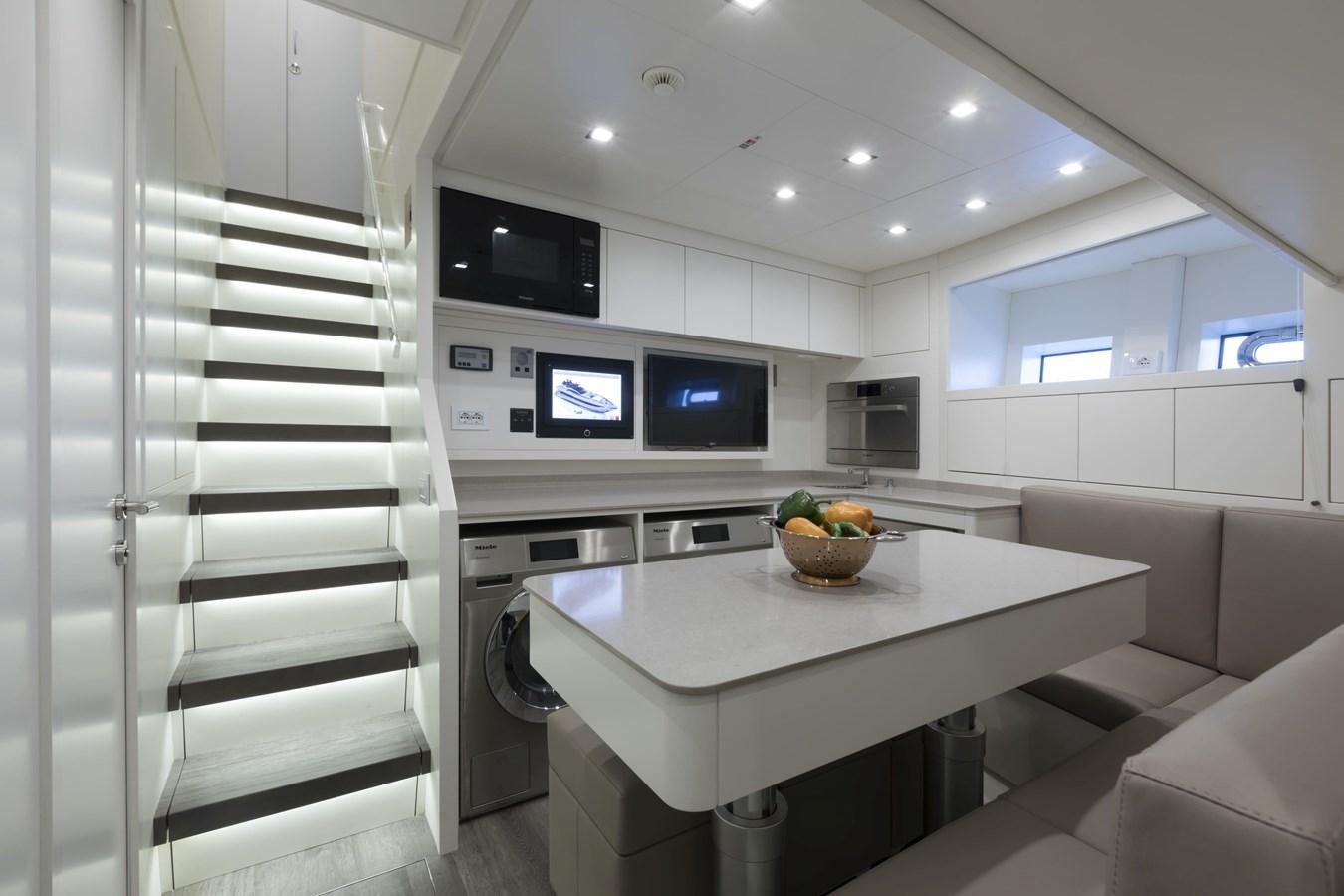 a kitchen with a large white counter aboard CRAZY TOO Yacht for Sale