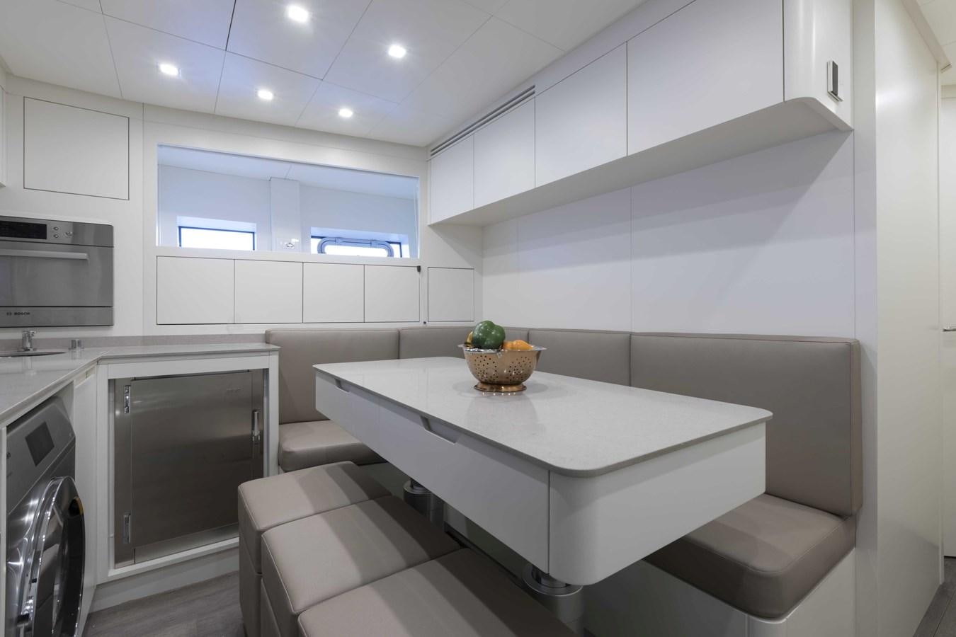a kitchen with white cabinets aboard CRAZY TOO Yacht for Sale