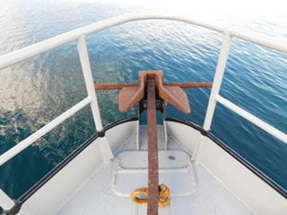 a wooden cross on a white railing aboard 1989 COMMERCIAL FIREBOAT Yacht for Sale