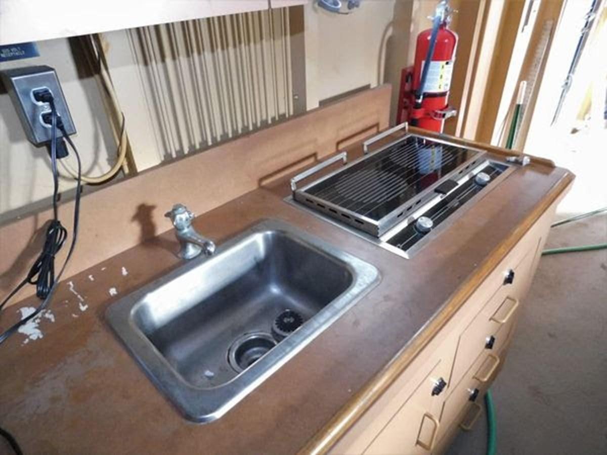 a sink with a laptop on it aboard 1989 COMMERCIAL FIREBOAT Yacht for Sale
