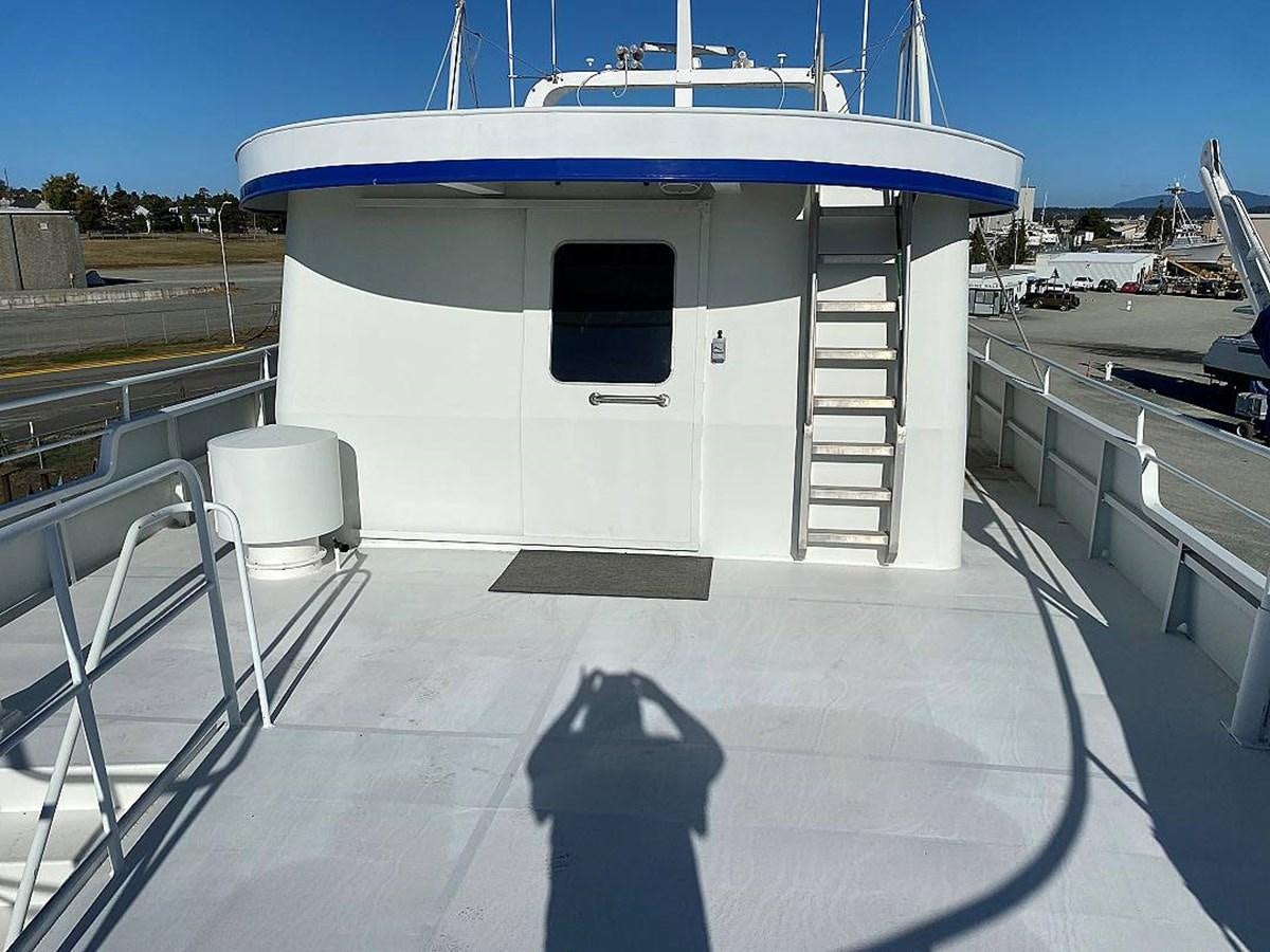 a white building with a blue roof aboard BEAR PAW Yacht for Sale