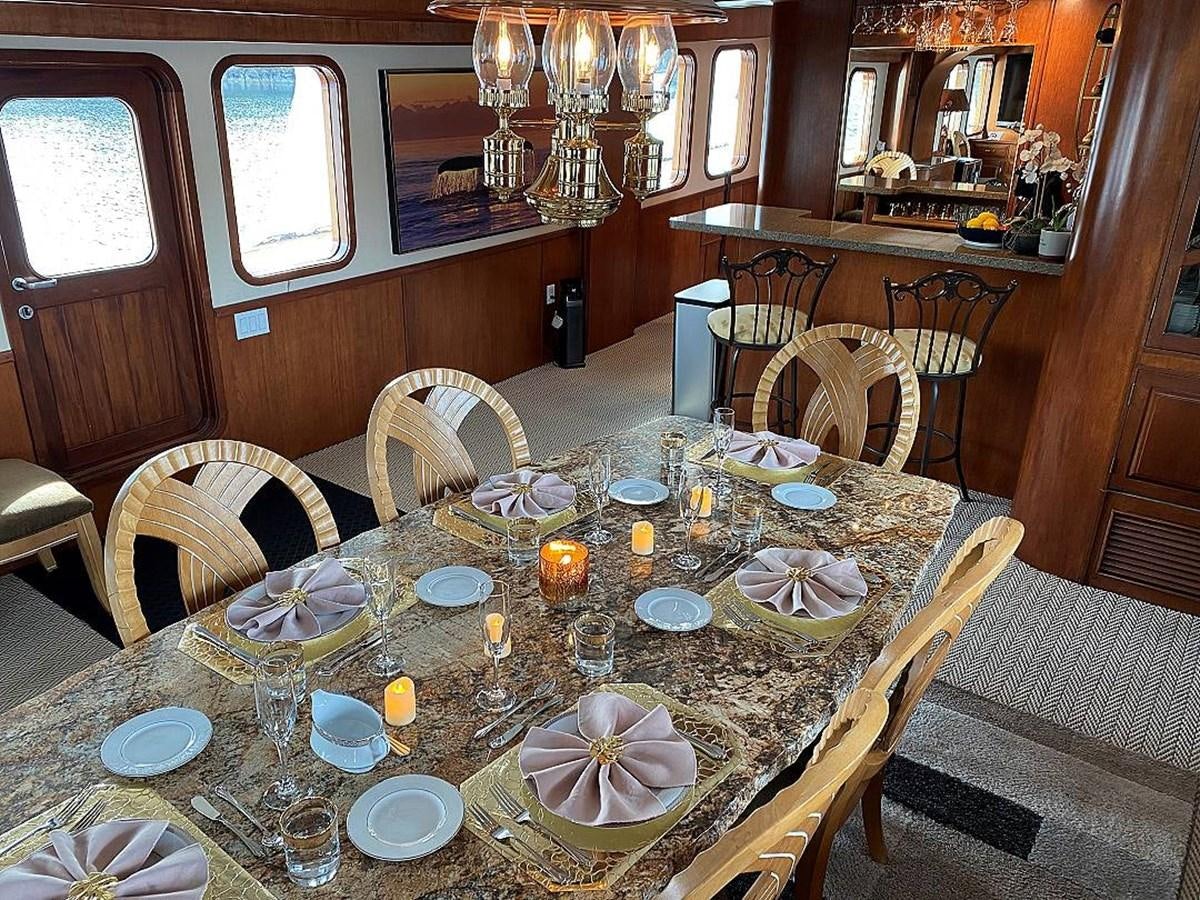 a dining room with a table set aboard BEAR PAW Yacht for Sale