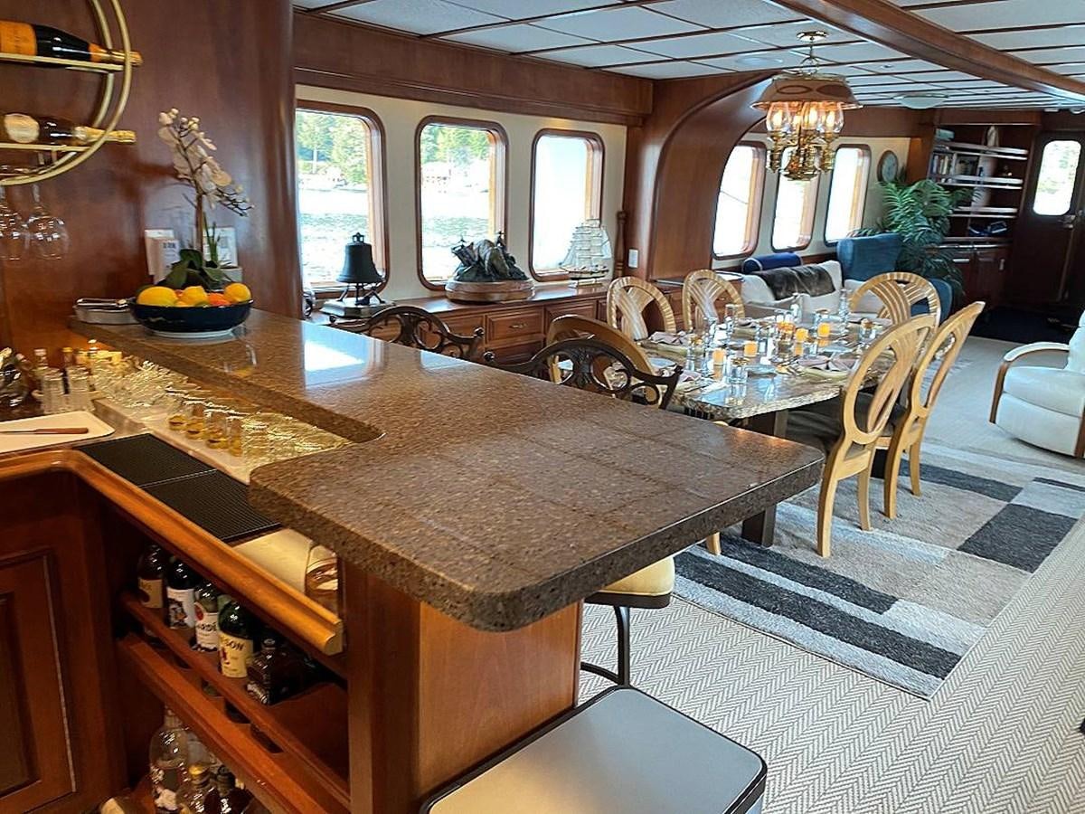 a large dining room with a large table and chairs aboard BEAR PAW Yacht for Sale