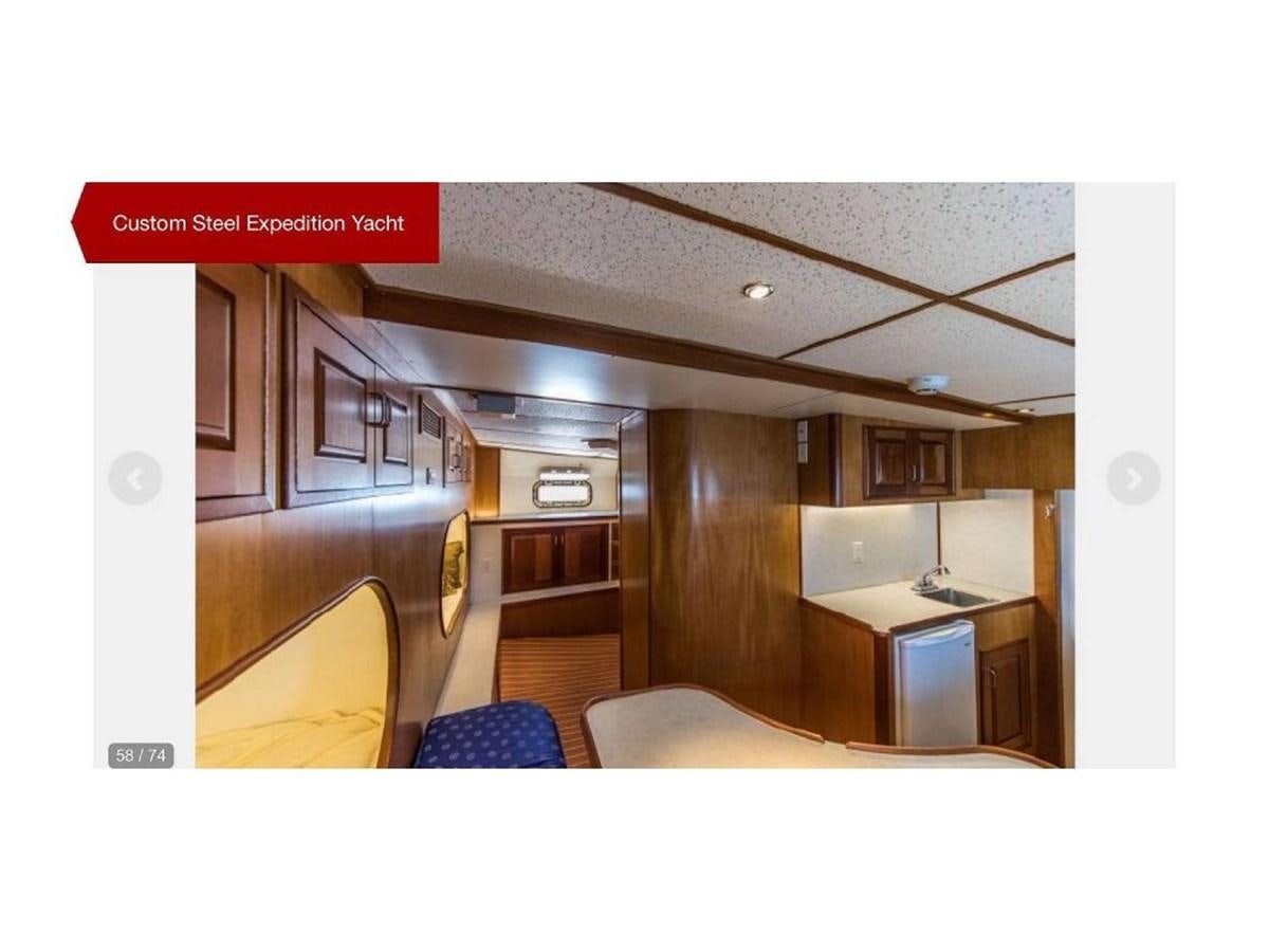 a large room with a desk and chairs aboard BEAR PAW Yacht for Sale