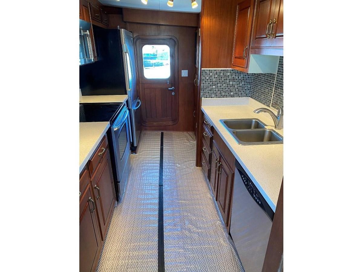 a kitchen with a sink and a stove aboard BEAR PAW Yacht for Sale