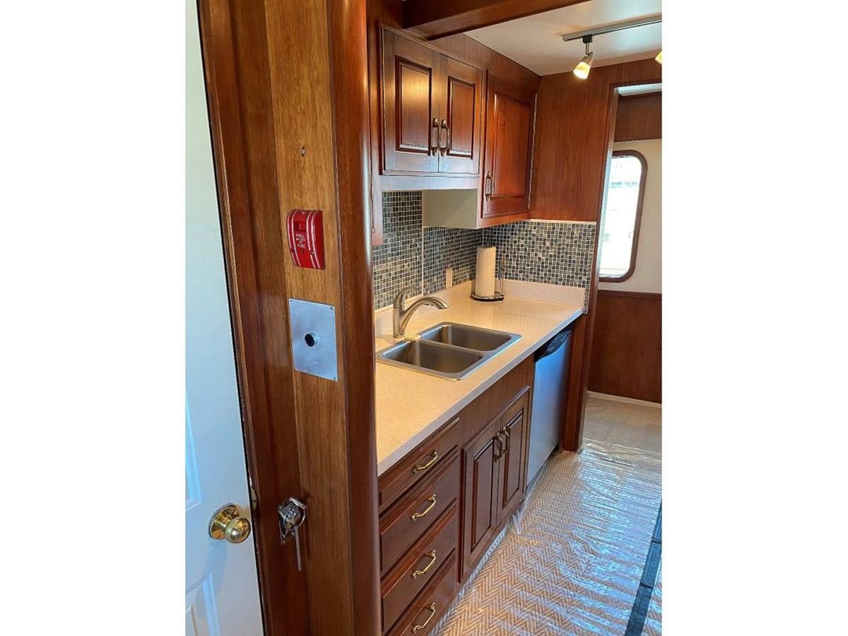 a kitchen with wooden cabinets aboard BEAR PAW Yacht for Sale