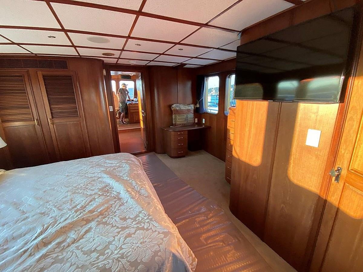 a room with a bed and a desk aboard BEAR PAW Yacht for Sale
