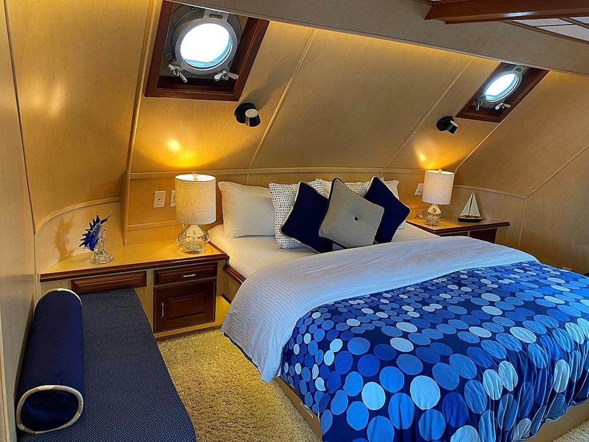 a hotel room with a bed and a desk aboard BEAR PAW Yacht for Sale