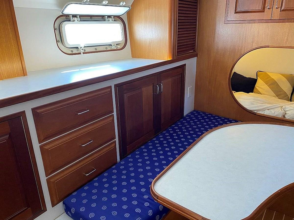 a bedroom with a blue bed aboard BEAR PAW Yacht for Sale