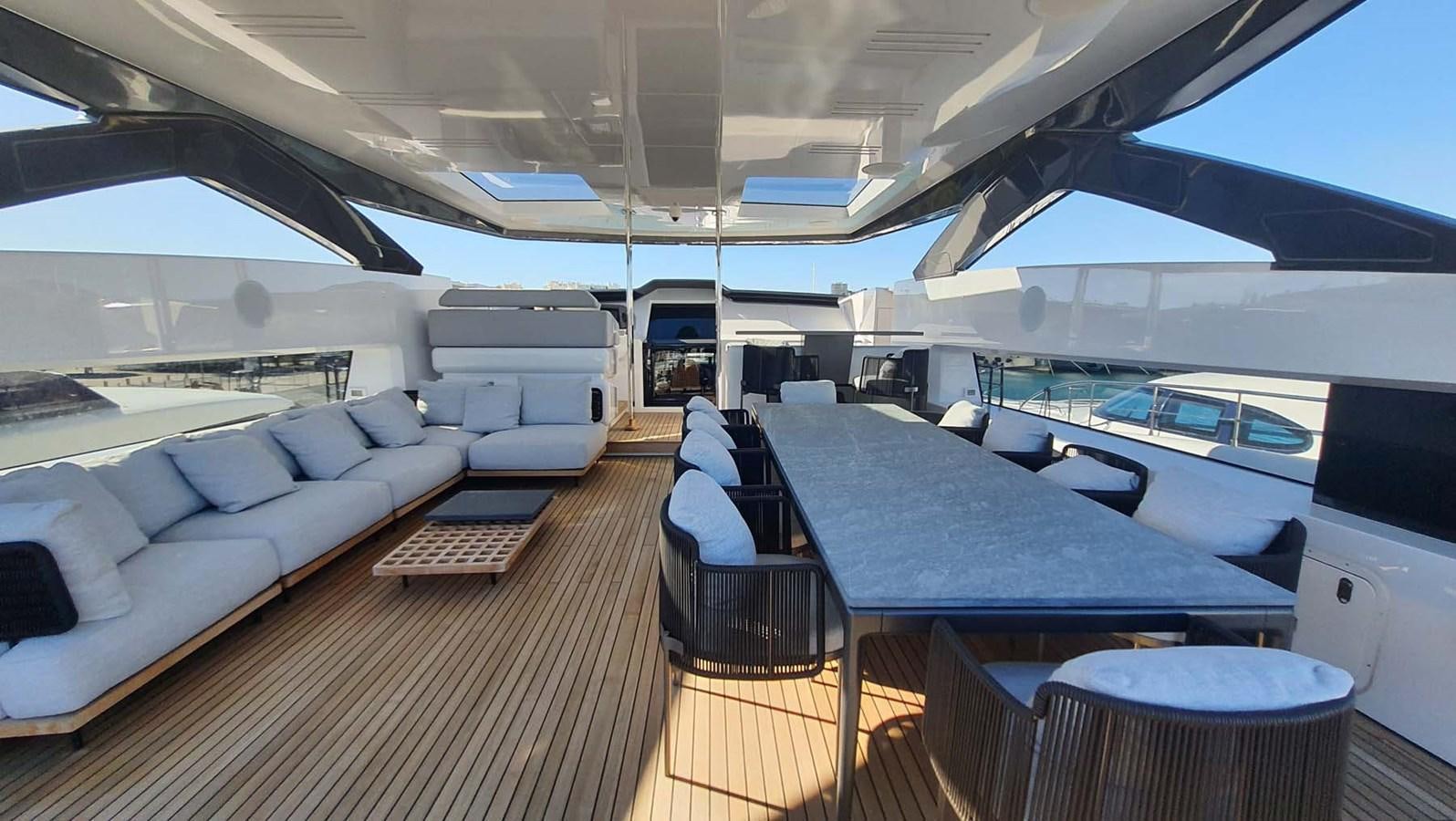 a large boat with a table and chairs on a deck aboard AMORES Yacht for Sale