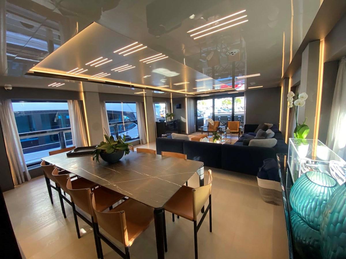 a room with a table and chairs aboard AMORES Yacht for Sale