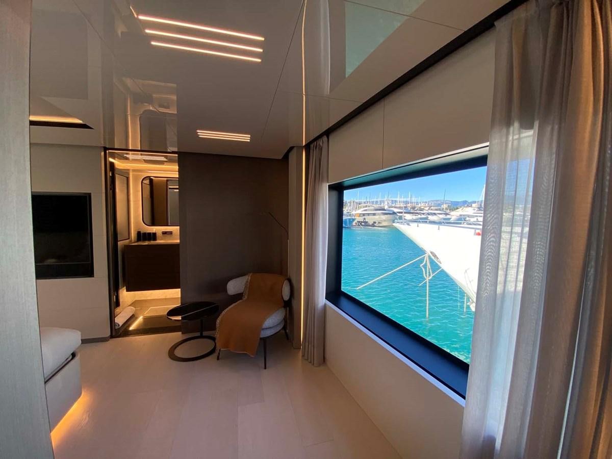 a room with a window and a view of the city aboard AMORES Yacht for Sale