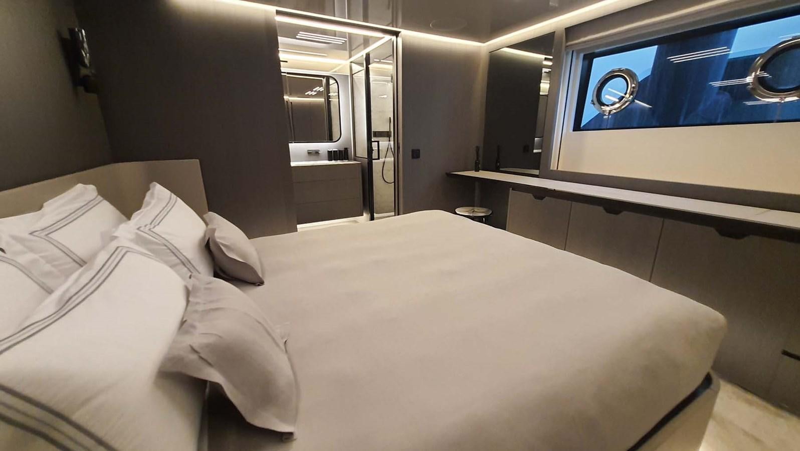 a bed with white sheets aboard AMORES Yacht for Sale