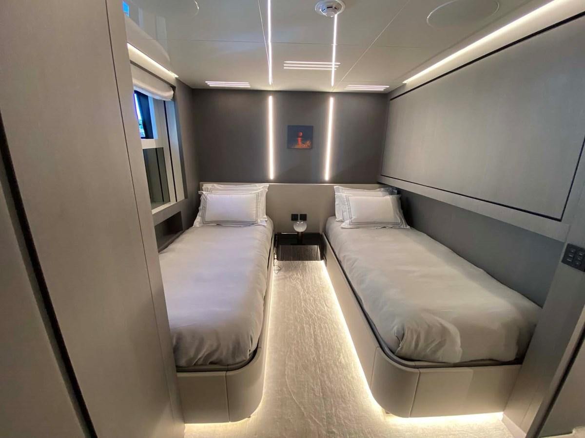 a room with beds and a window aboard AMORES Yacht for Sale