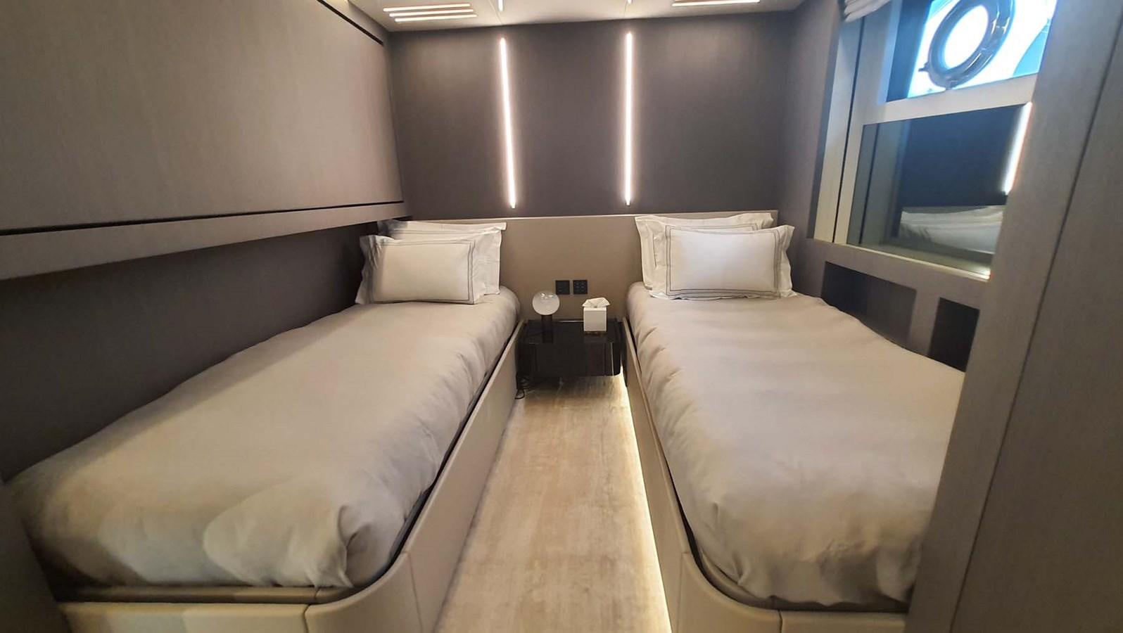 a room with two beds aboard AMORES Yacht for Sale