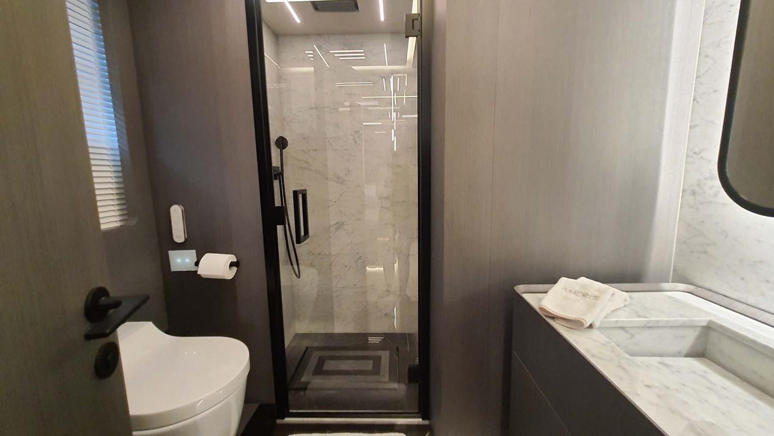 a bathroom with a glass shower door aboard AMORES Yacht for Sale