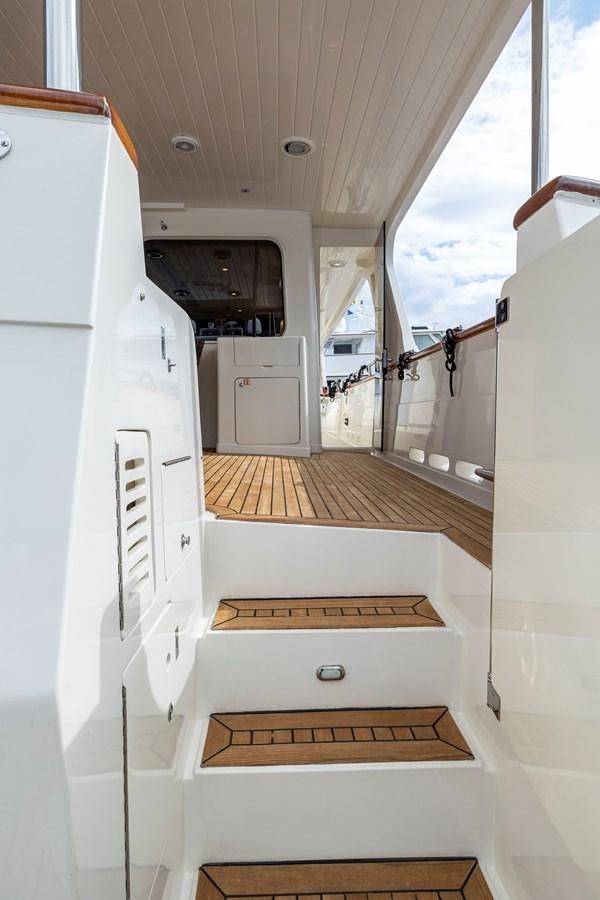 a white room with a large white cabinet and a wood floor aboard ANNIE Yacht for Sale