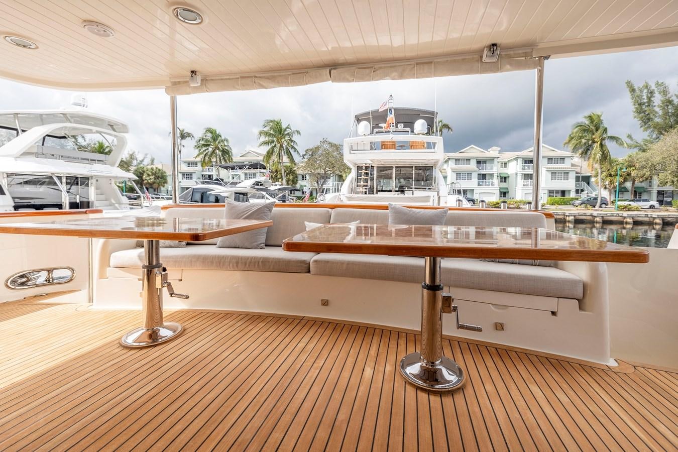 a table with chairs and a window overlooking a city aboard ANNIE Yacht for Sale