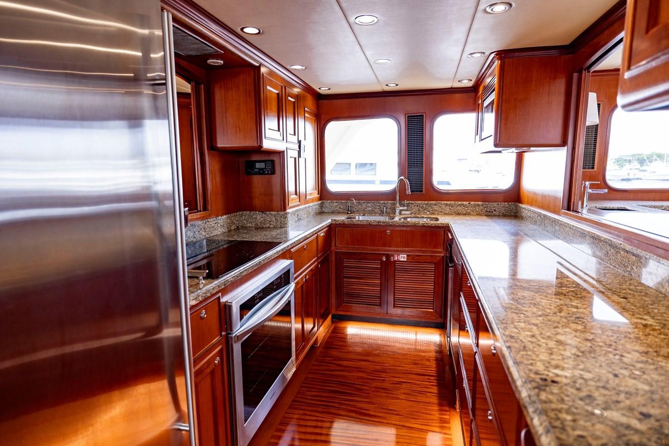 a kitchen with wooden cabinets aboard ANNIE Yacht for Sale