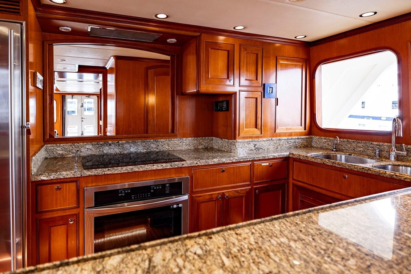 a kitchen with wooden cabinets aboard ANNIE Yacht for Sale
