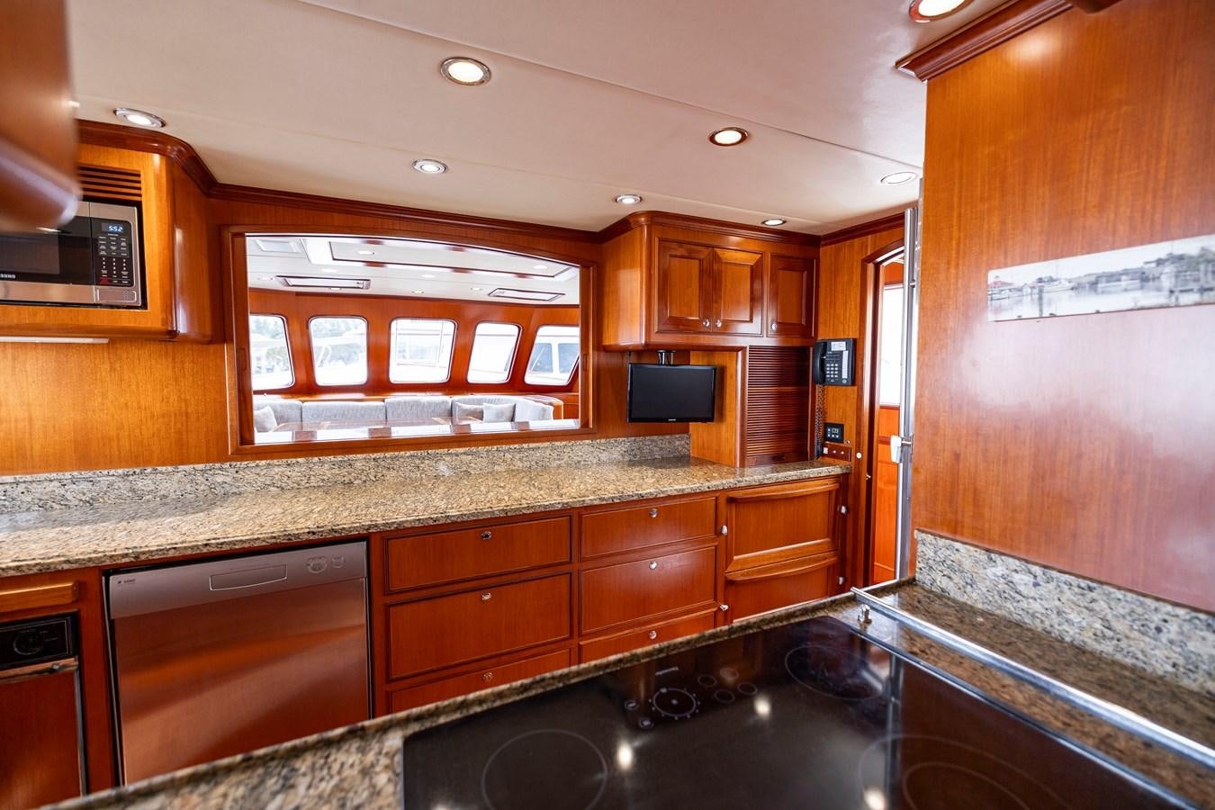 a kitchen with wooden cabinets aboard ANNIE Yacht for Sale