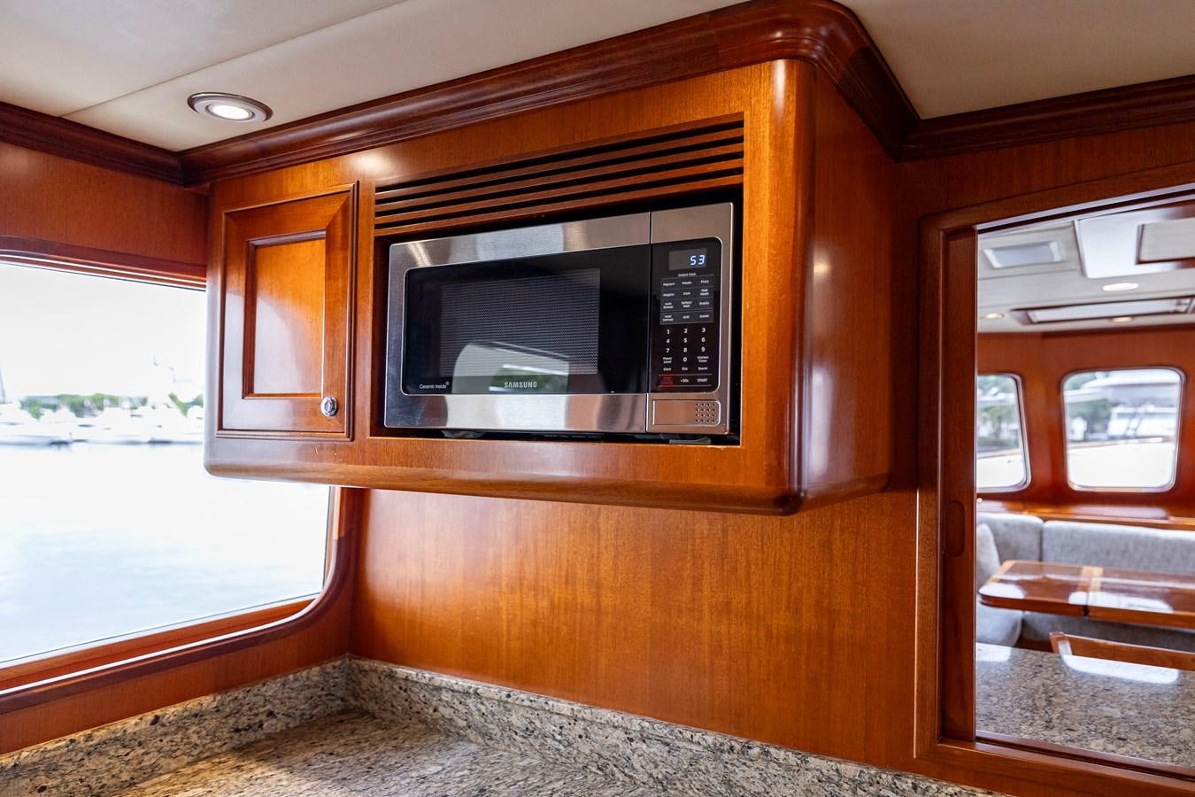 a microwave oven in a wooden cabinet aboard ANNIE Yacht for Sale