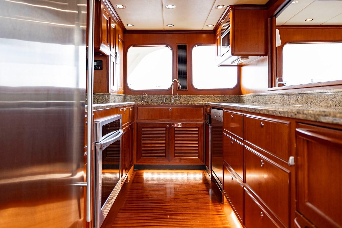 a kitchen with wooden cabinets aboard ANNIE Yacht for Sale