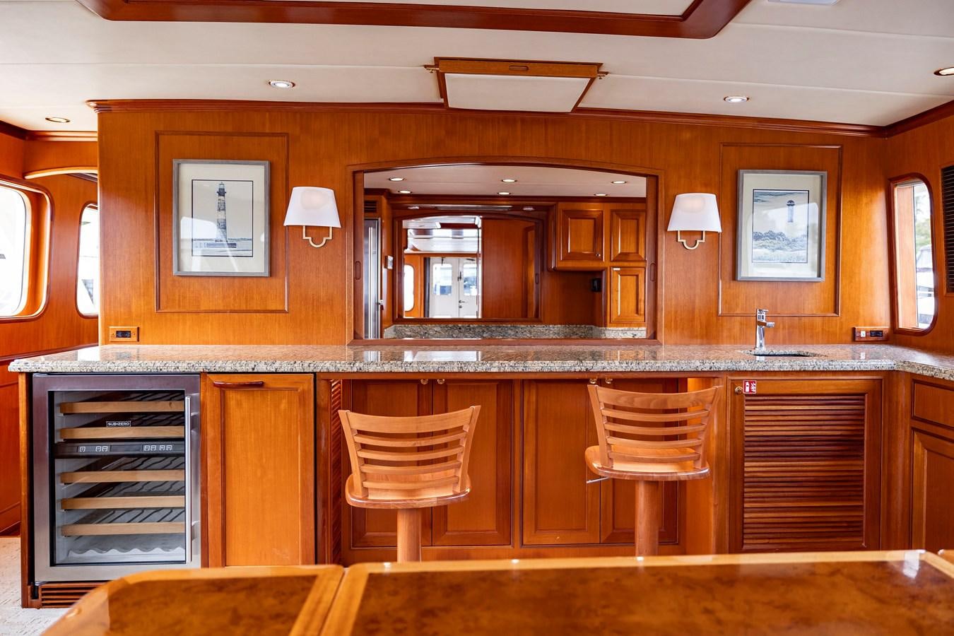 a room with a few chairs and a counter with a mirror aboard ANNIE Yacht for Sale