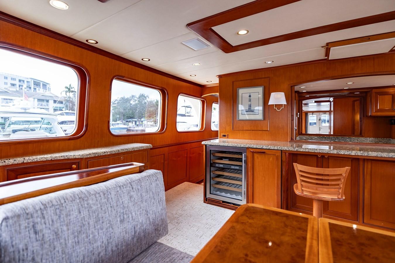 a large kitchen with a bar and a couch aboard ANNIE Yacht for Sale