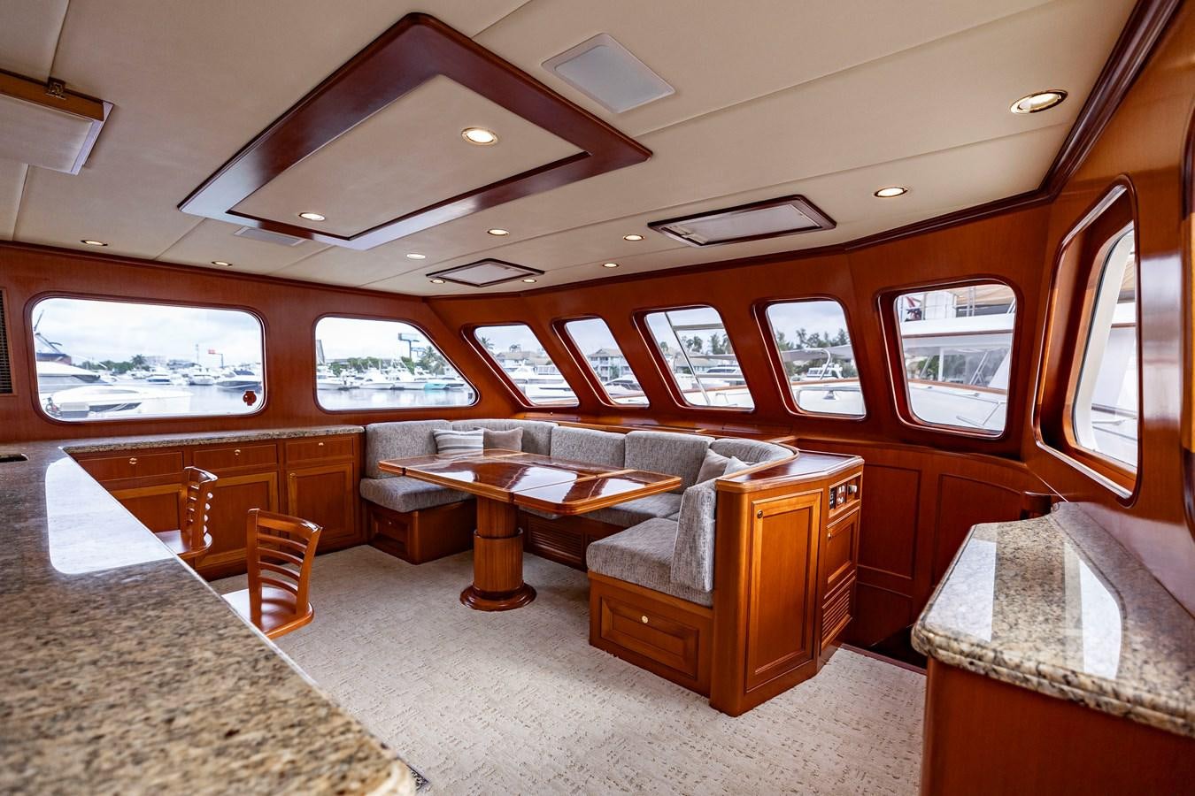 a room with leather couches and a table aboard ANNIE Yacht for Sale