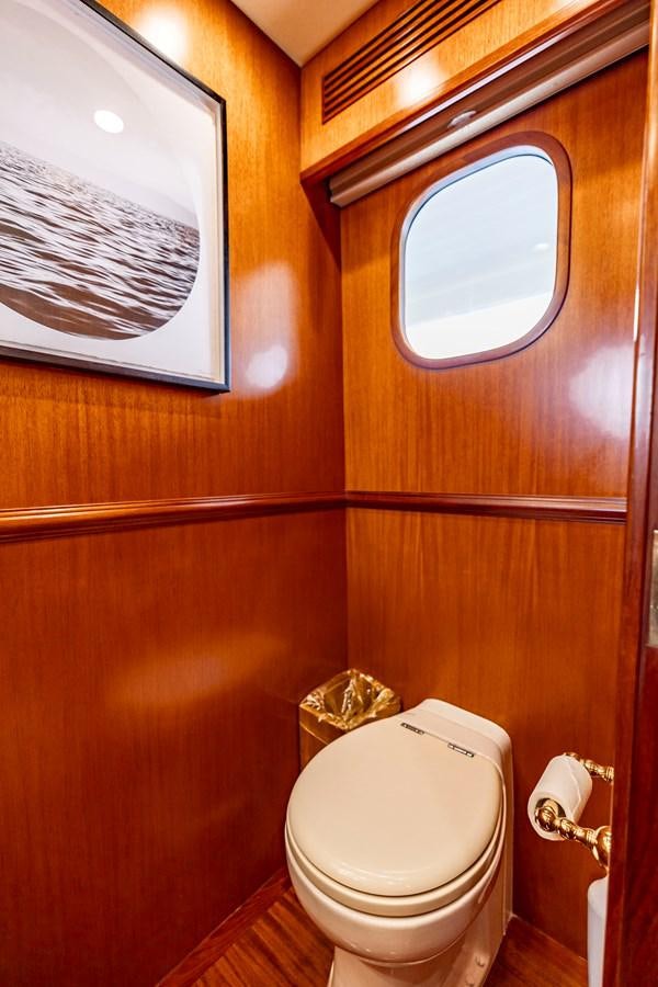 a toilet with a mirror above it aboard ANNIE Yacht for Sale