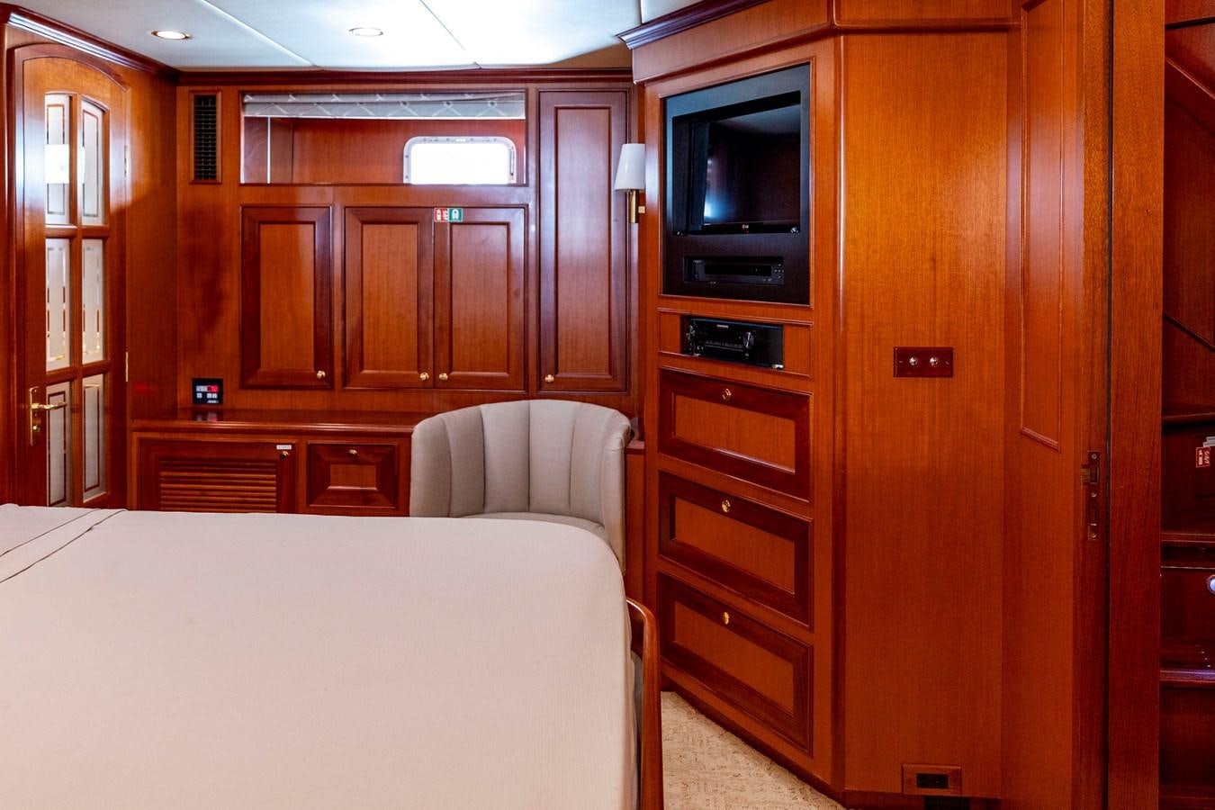 a bedroom with a bed and a television aboard ANNIE Yacht for Sale